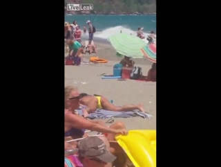 a woman on a public beach decided to rub her pussy, thinking that no one sees it